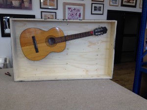 Bespoke Box framing a Guitar